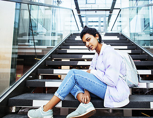 Image showing young cute indian girl at university building sitting on stairs 