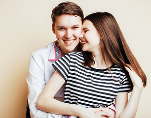 Image showing young pretty teenage couple, hipster guy with his girlfriend happy smiling and hugging isolated on white background, lifestyle people concept 