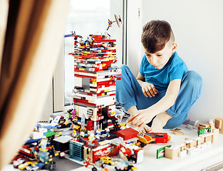 Image showing little cute preschooler boy playing lego toys at home happy smiling, lifestyle children concept 