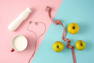 Image showing The green apple and bottle of yogurt with measure tape