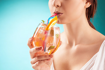 Image showing The pretty woman drinking cocktail. Emotion. Hairstyle.