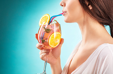 Image showing The pretty woman drinking cocktail. Emotion. Hairstyle.