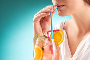 Image showing The pretty woman drinking cocktail. Emotion. Hairstyle.