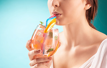 Image showing The pretty woman drinking cocktail. Emotion. Hairstyle.