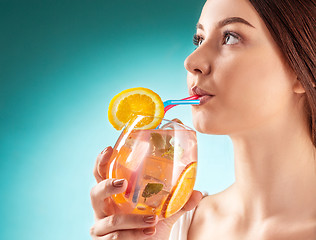 Image showing The pretty woman drinking cocktail. Emotion. Hairstyle.