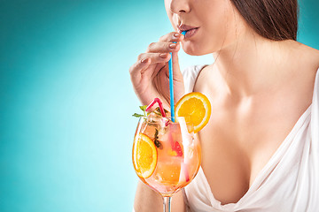 Image showing The pretty woman drinking cocktail. Emotion. Hairstyle.