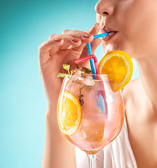 Image showing The pretty woman drinking cocktail. Emotion. Hairstyle.