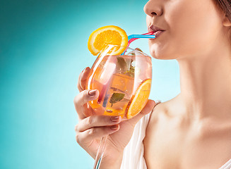 Image showing The pretty woman drinking cocktail. Emotion. Hairstyle.