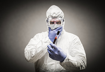 Image showing Man Wearing HAZMAT Protective Clothing Holding Test Tube Filled 