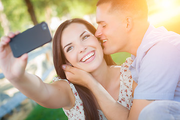Image showing Happy Mixed Race Couple Taking Self Portrait with A Smart Phone 