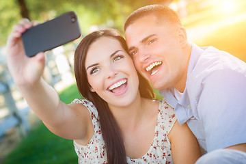 Image showing Happy Mixed Race Couple Taking Self Portrait with A Smart Phone 