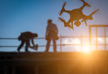 Image showing Silhouette of Unmanned Aircraft System (UAV) Quadcopter Drone In