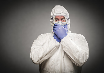 Image showing Man Covering Mouth With Hands Wearing HAZMAT Protective Clothing