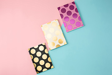 Image showing The three notebooks on colorful baground