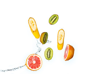 Image showing Fresh fruits falling in water splash, isolated on white background