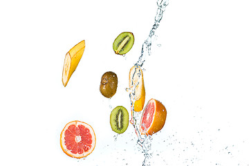 Image showing Fresh fruits falling in water splash, isolated on white background