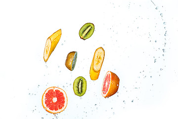 Image showing Fresh fruits falling in water splash, isolated on white background