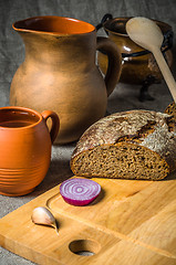 Image showing Still life with homemade bread and pottery