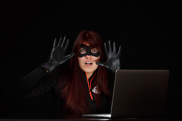 Image showing Brunette spy with raised hands