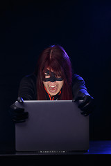 Image showing Young brunette hacker at night