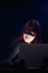 Image showing Woman in mask with laptop