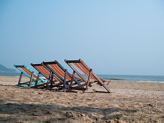 Image showing Four deck chairs on beach