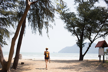 Image showing Young girl walks along beach