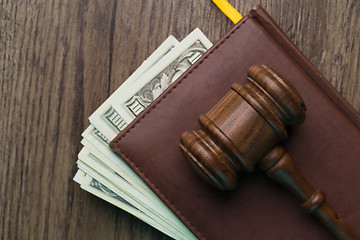 Image showing Wooden table with hammer, banknotes