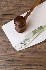 Image showing Hammer on envelope with money