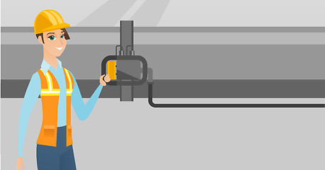 Image showing Operator checking detector on gas pipeline.