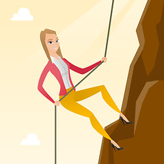 Image showing Business woman climbing on the mountain.