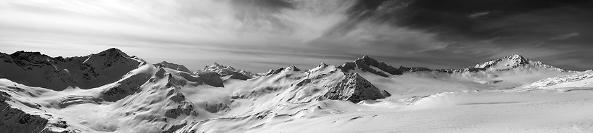 Image showing Black and white panorama of Caucasus Mountains in snow winter ev