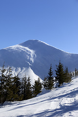 Image showing Snow winter mountains at sun windy day