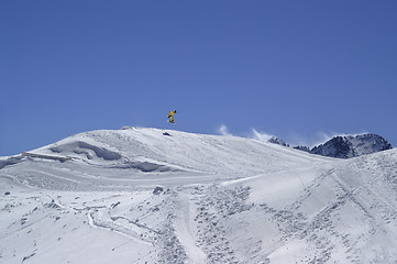 Image showing Snowboarder jumping in terrain park at ski resort on sun winter 