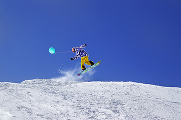 Image showing Snowboarder jump with toy balloon in terrain park at ski resort 