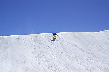 Image showing Snowboarder downhill in terrain park on ski resort at sun winter