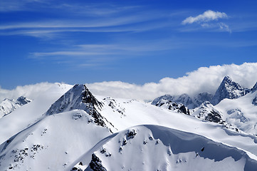 Image showing Winter mountains with snow cornice and blue sky with clouds in n