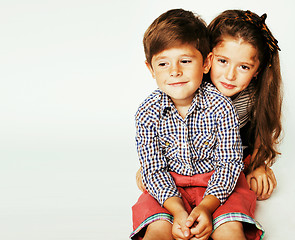 Image showing little cute boy and girl hugging playing on white background, ha