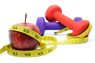 Image showing Dumbell with measuring tape and red apple