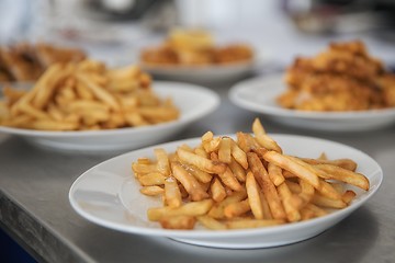 Image showing French fries and meat on the table