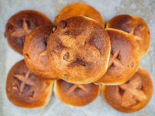 Image showing Pumkin seed buns on baking paper sfter baking at close-up in a n