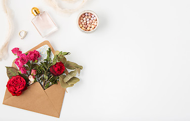 Image showing Love or valentine\'s day concept. Red beautiful roses in envelopen