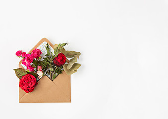 Image showing Love or valentine\'s day concept. Red beautiful roses in envelopen