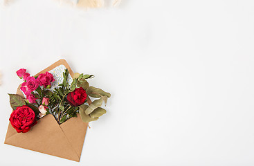 Image showing Love or valentine\'s day concept. Red beautiful roses in envelopen