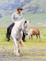 Image showing Woman riding a horse