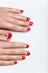 Image showing Female hands with red and white nails