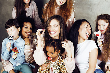 Image showing Lifestyle and people concept: young pretty diversity nations woman with different age children celebrating on birth day party together happy smiling, making selfie. African-american, asian and caucasi