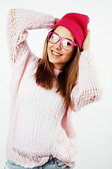 Image showing young pretty teenage hipster girl posing emotional happy smiling on white background, lifestyle people concept 