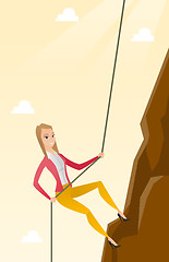 Image showing Business woman climbing on the mountain.