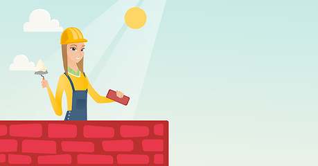 Image showing Bricklayer working with spatula and brick.